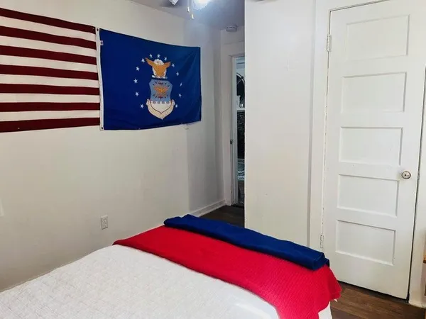 a bedroom with a bed and a wall painting