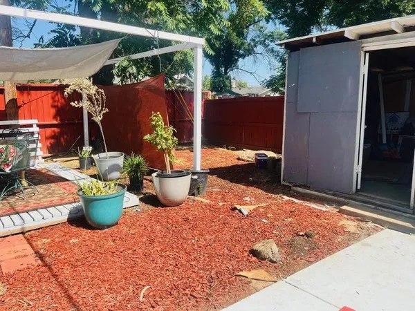 a view of a backyard of the house with potted plants
