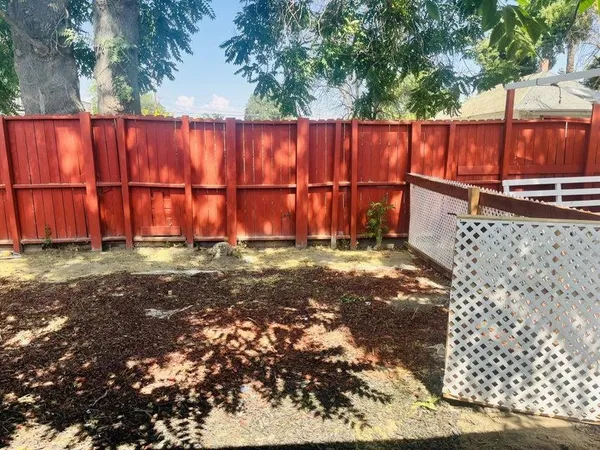a view of small yard with wooden fence