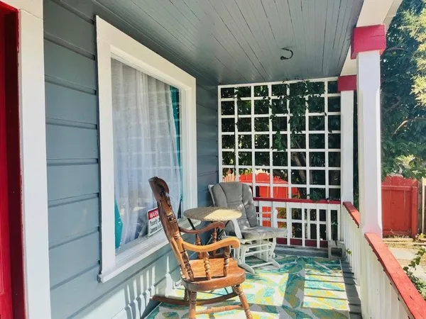 a balcony with table and chairs