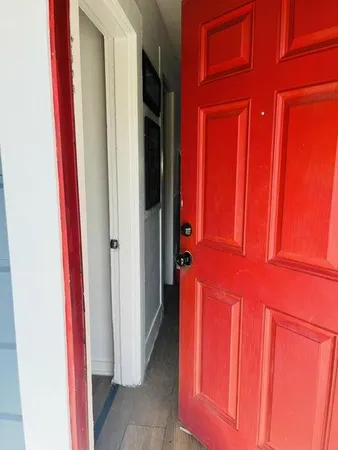 a view of a hallway with closet and front door