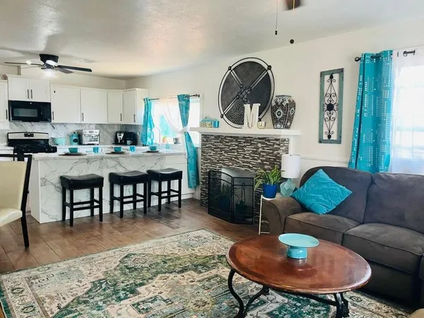 a living room with furniture a rug and a fireplace