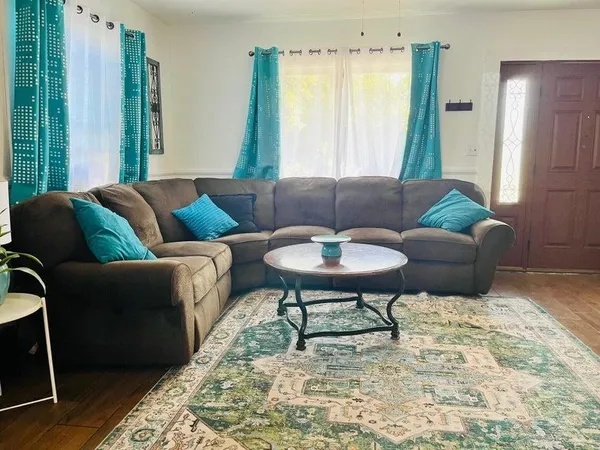 a living room with furniture and a rug