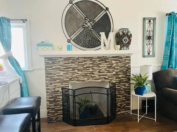 a living room with furniture and a fireplace