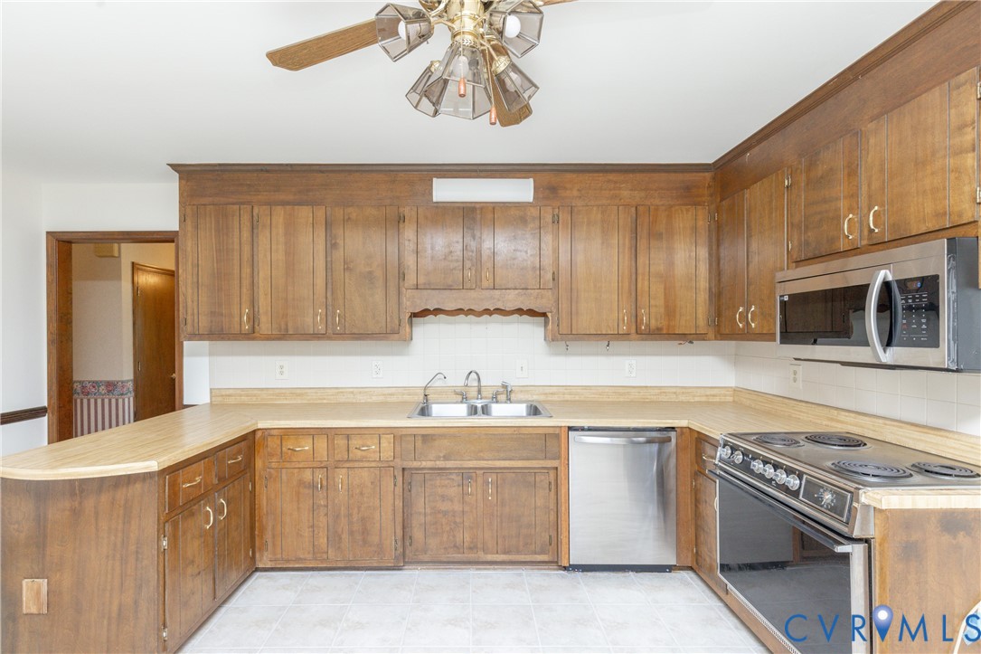 617 Rebel Ridge Road Colonial Heights, VA 23834 - Photo 16 of 49 a kitchen with a sink cabinets and stainless steel appliances
