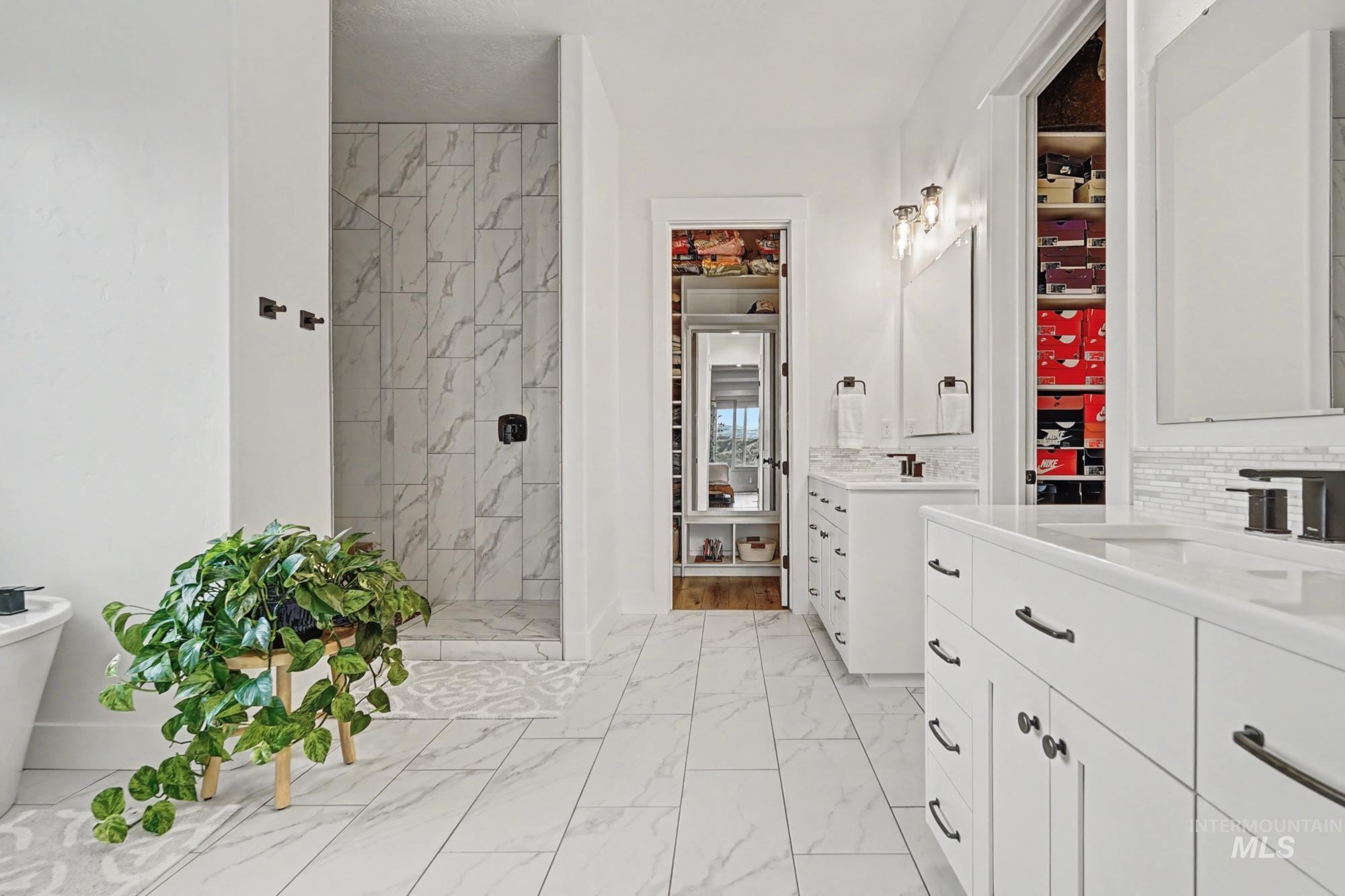 18357 North Burnt Car Way Boise, ID 83714 - Photo 23 of 48 Full bath with a marble finish shower, two vanities, and light marble finish floors