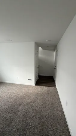 a brick house with a bench next to a road