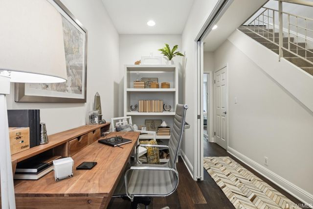 a view of walk in closet with wooden floor