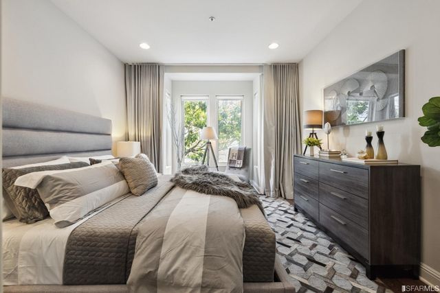 a living room with furniture a fireplace and a potted plant