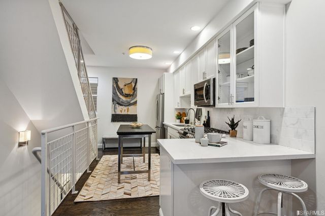 a bedroom with a bed a mirror and a lamp