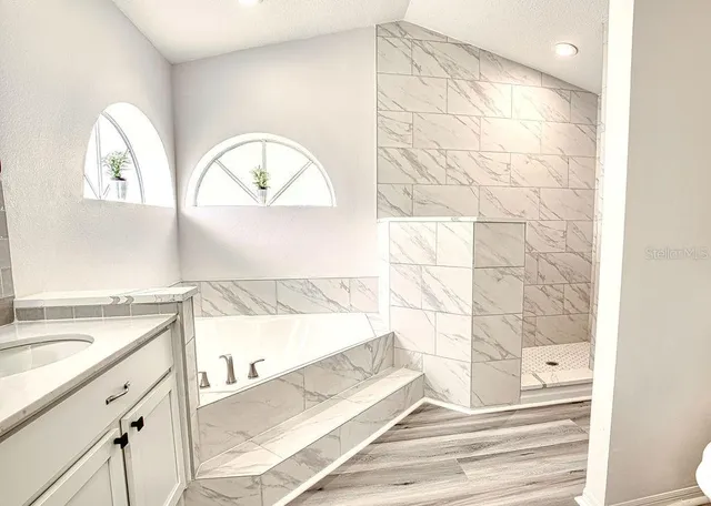 a view of a bathroom with a sink and a mirror