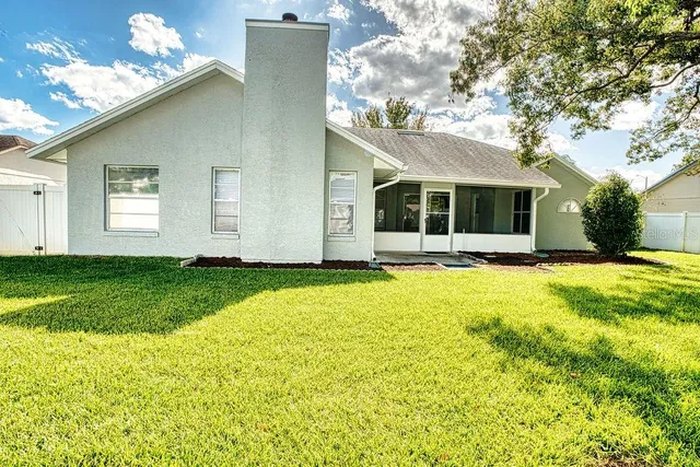 a front view of house with yard and green space