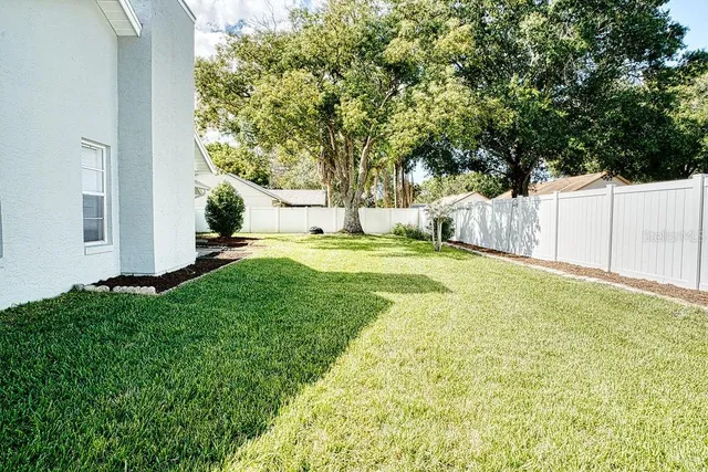 a view of a yard with swimming pool