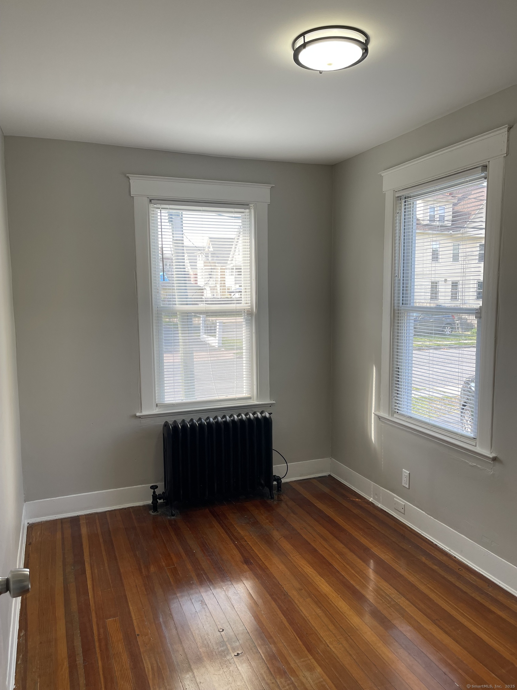 80 Hazel Street Hartford, CT 06106 - Photo 12 of 32 an empty room with wooden floor and windows