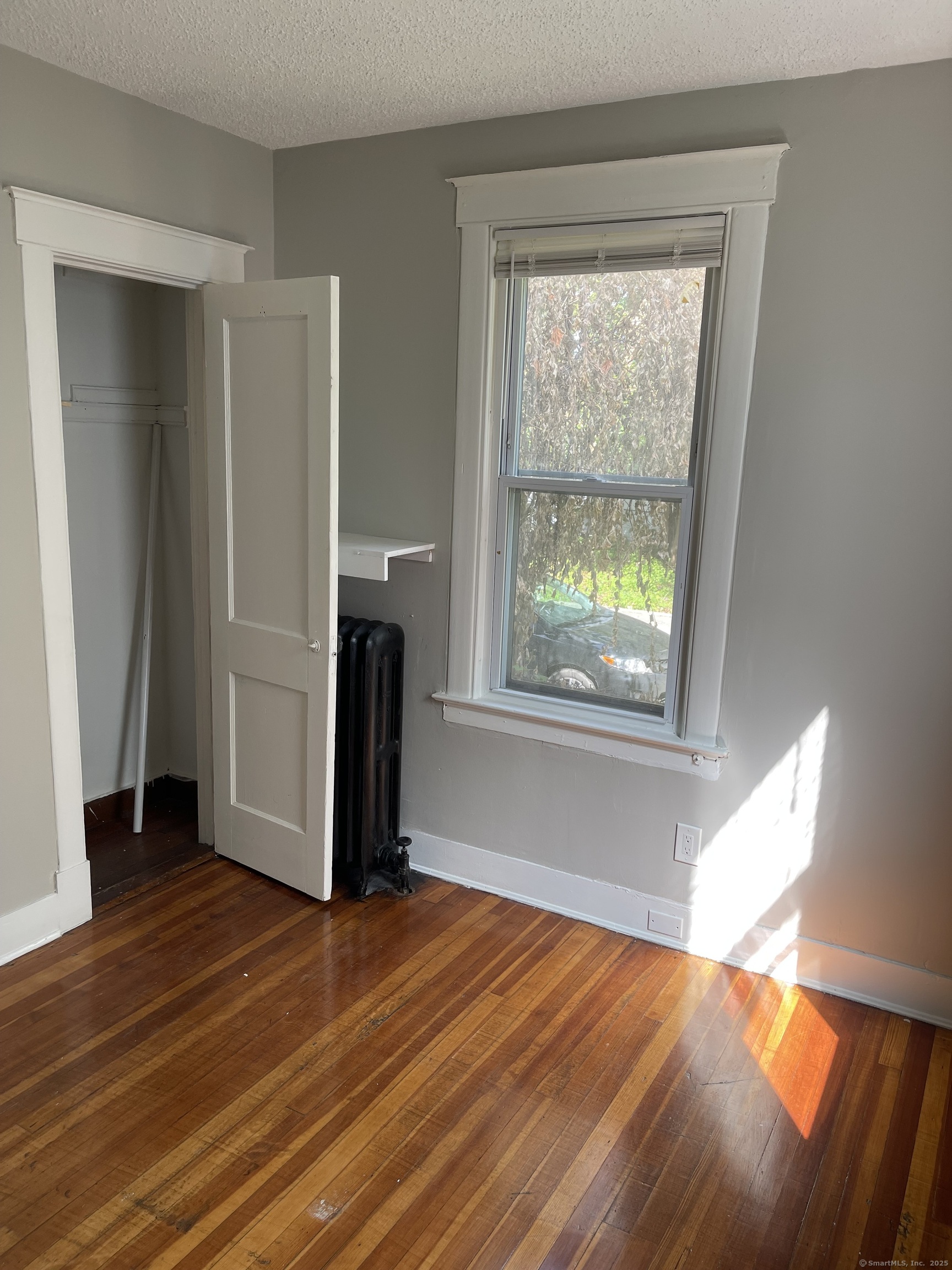 80 Hazel Street Hartford, CT 06106 - Photo 14 of 32 a view of empty room with wooden floor and fan