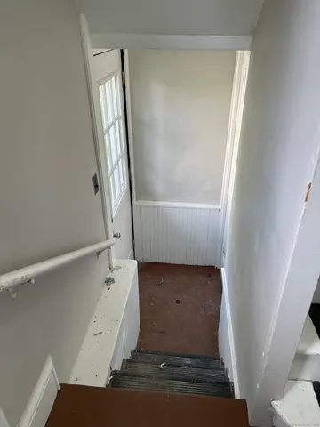 a view of staircase with white walls