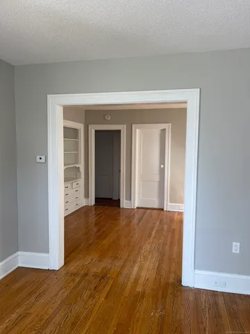 a view of an empty room and wooden floor