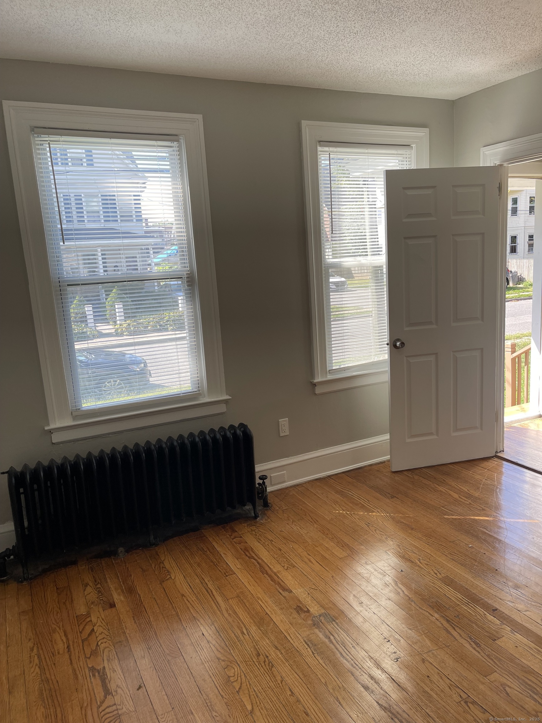 80 Hazel Street Hartford, CT 06106 - Photo 22 of 32 a view of an empty room with wooden floor and a window