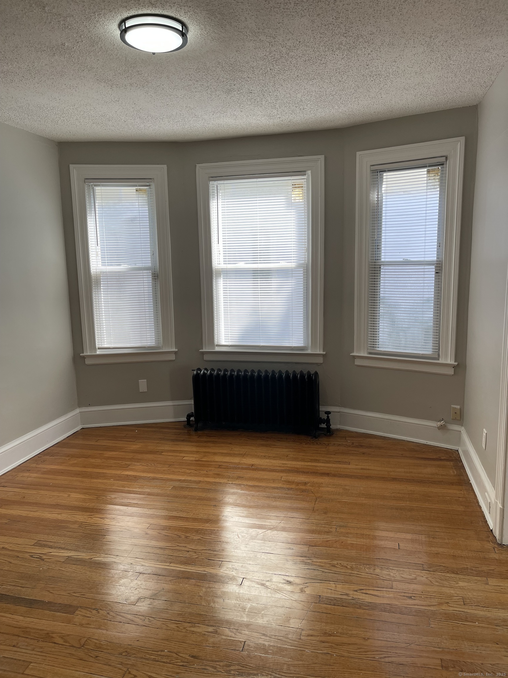 80 Hazel Street Hartford, CT 06106 - Photo 26 of 32 a view of an empty room with wooden floor and a window