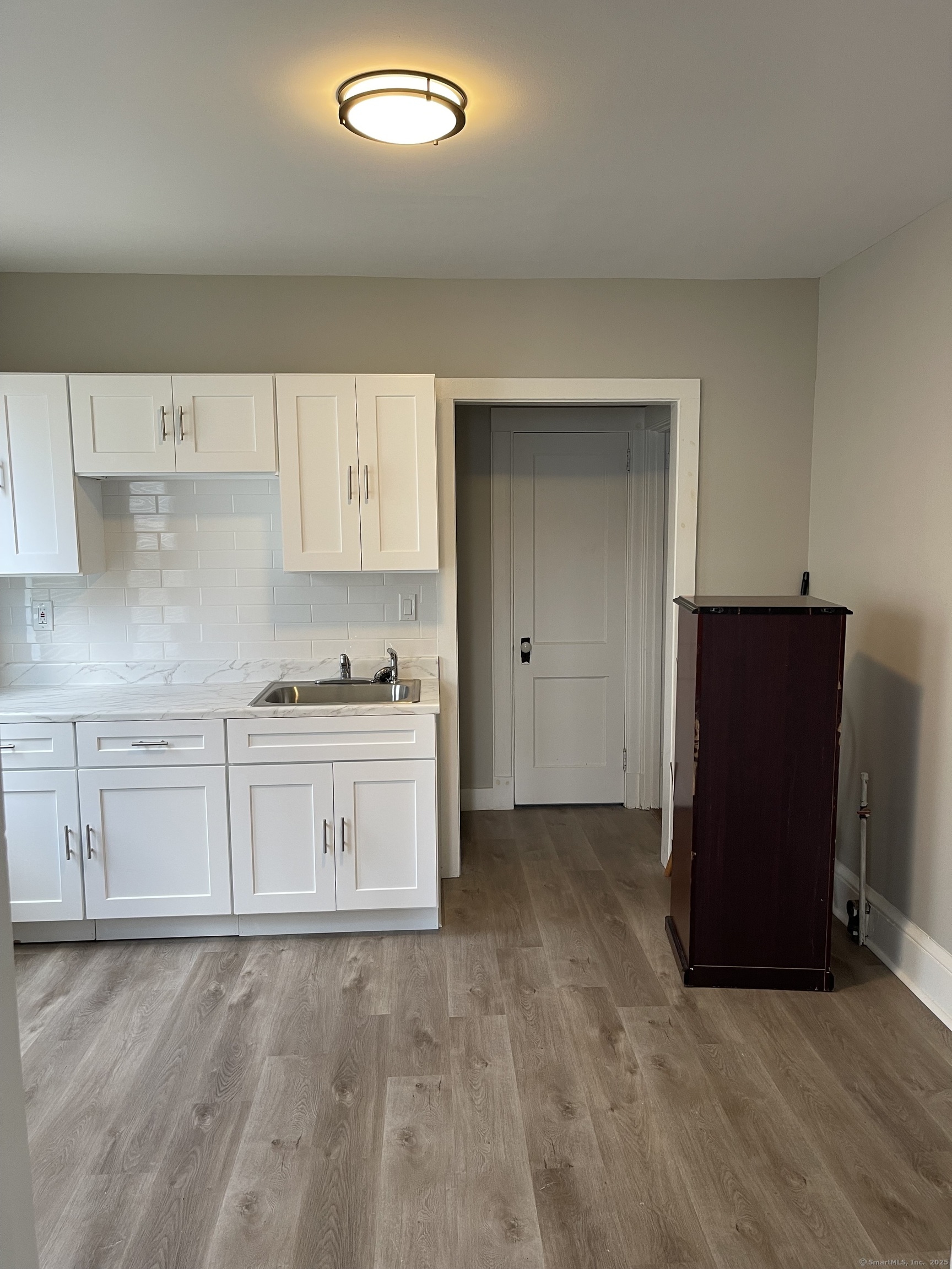 80 Hazel Street Hartford, CT 06106 - Photo 3 of 32 an empty room with cabinet and mirrors