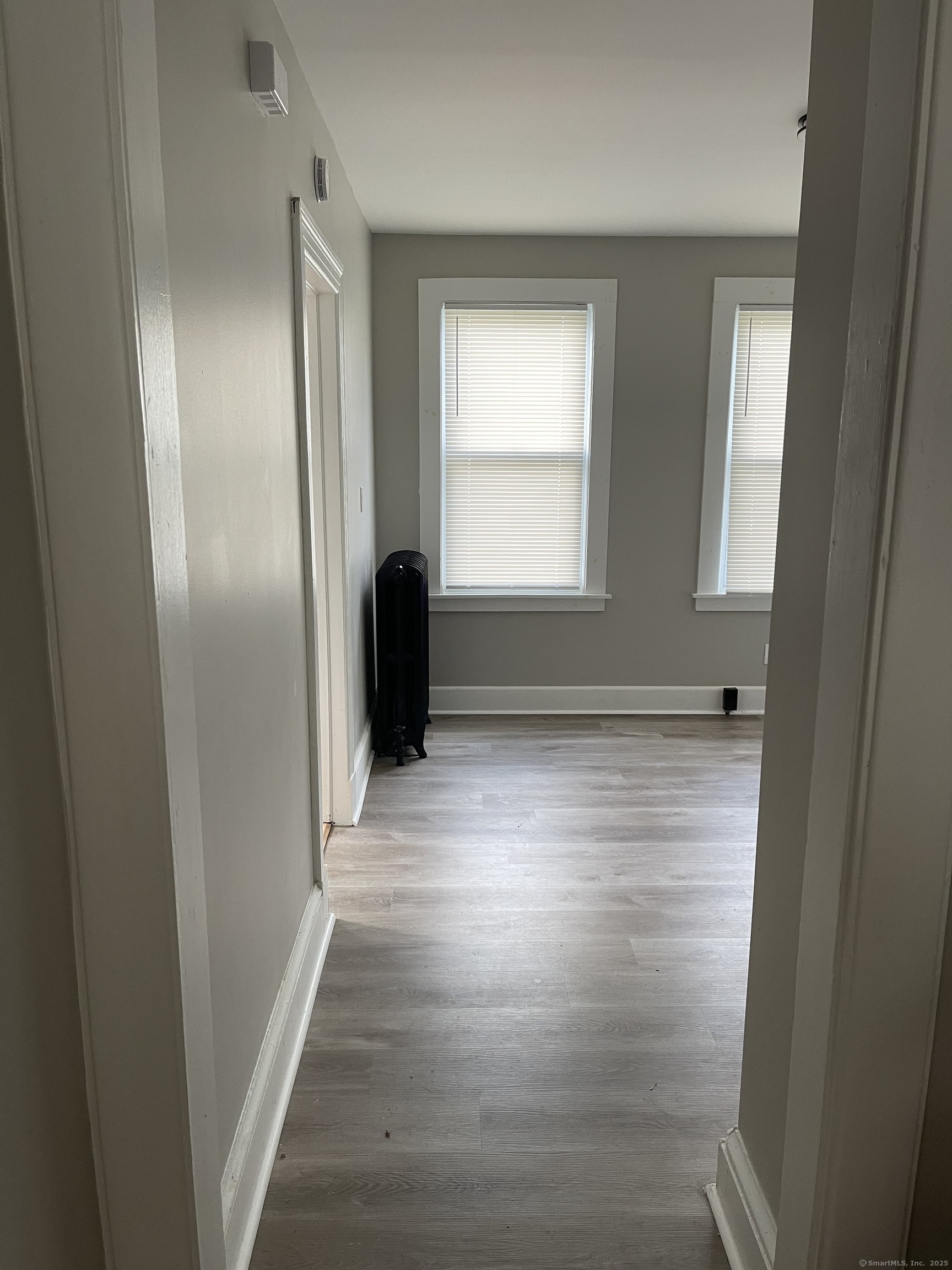80 Hazel Street Hartford, CT 06106 - Photo 4 of 32 a view of an empty room with wooden floor and a window