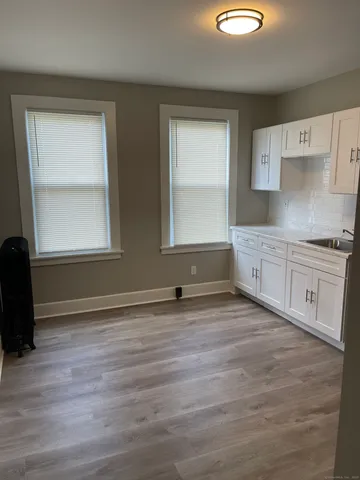 a view of a kitchen with a sink and dishwasher next to a window