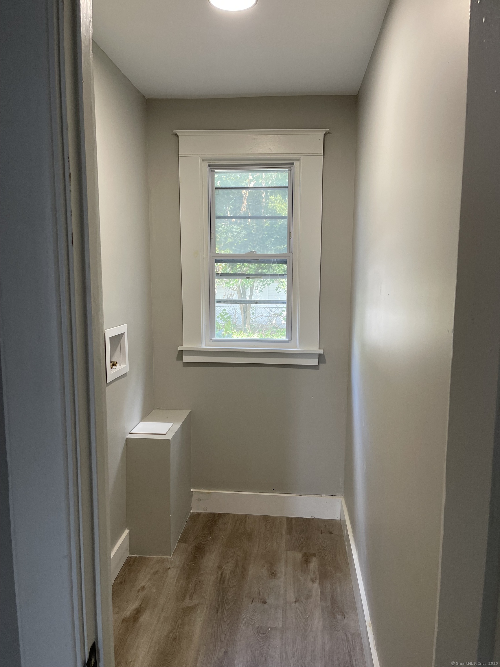 80 Hazel Street Hartford, CT 06106 - Photo 8 of 32 a view of an empty room with wooden floor and a window