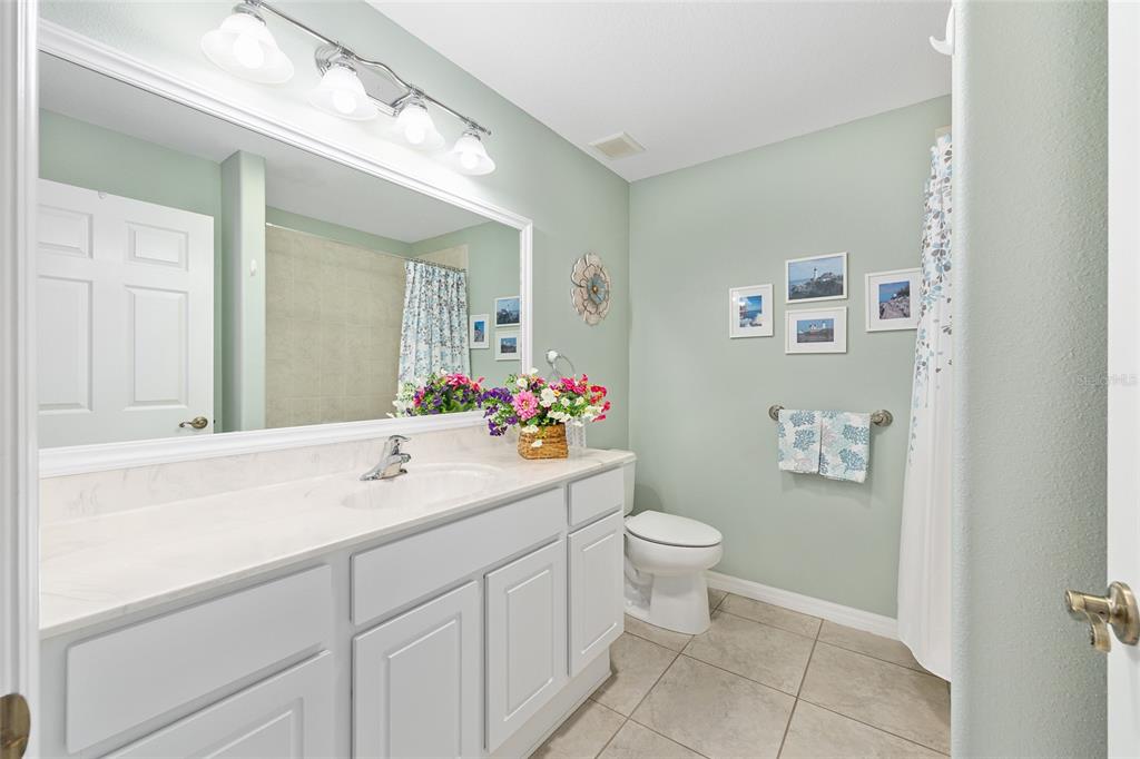16339 Southwest 14th Avenue Road Ocala, FL 34473 - Photo 15 of 22 a bathroom with a sink toilet and a mirror