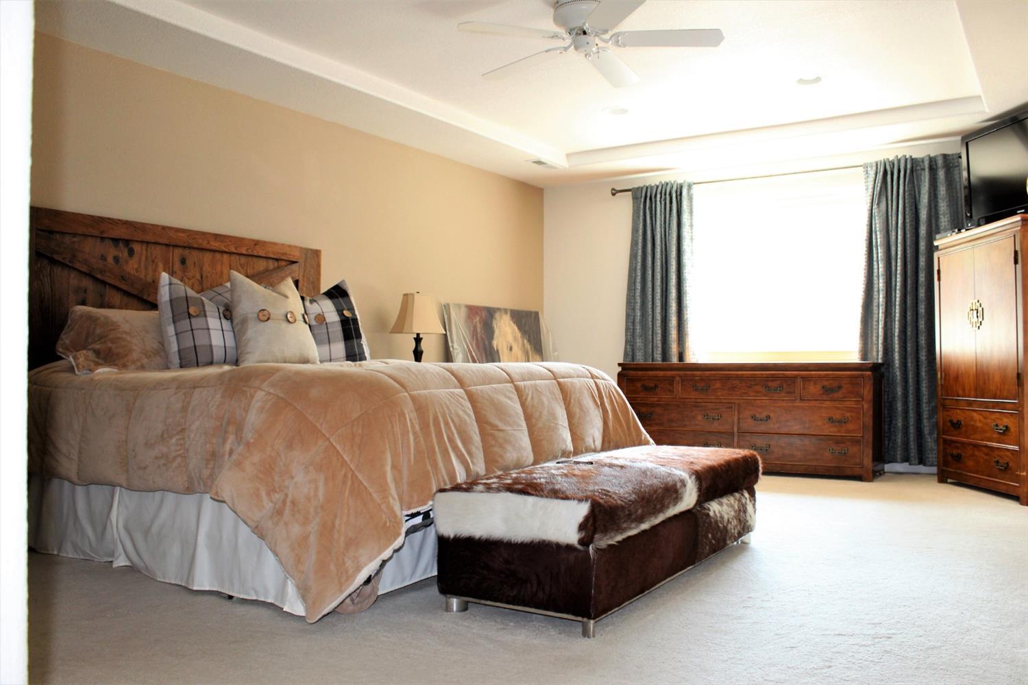 1246 Poppy Ridge Drive Eagle Point, OR 97524 - Photo 17 of 34 a spacious bedroom with a bed and glass door