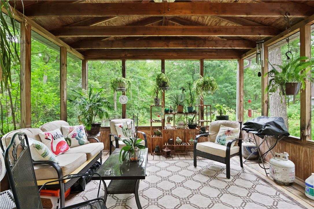 209 Remington Road East Stroudsburg, PA 18301 - Photo 11 of 41 A spacious screened porch, complete with a natural wood ceiling, offers a tranquil escape with a verdant outdoor view.