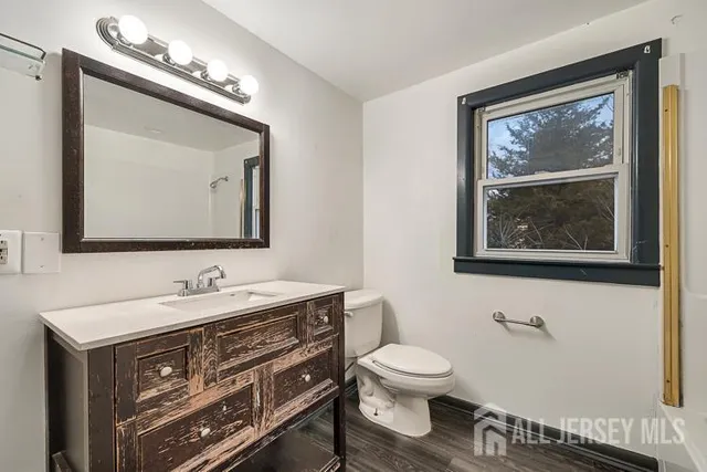 a bathroom with a toilet sink and mirror
