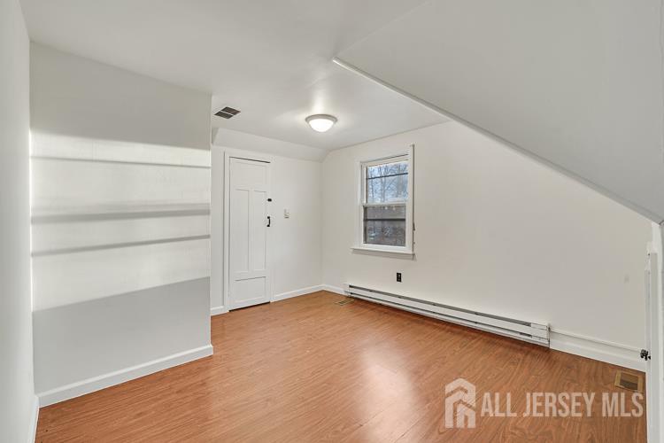 746 Spruce Road North Brunswick, NJ 08902 - Photo 17 of 29 a view of empty room with window and wooden floor