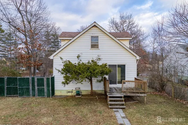 a view of a house with a yard and furniture