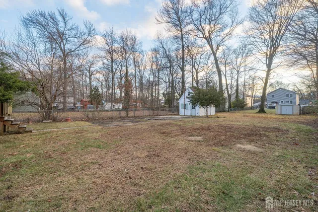 a view of large yard with large trees