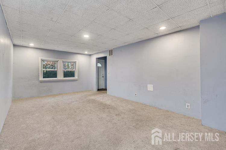 746 Spruce Road North Brunswick, NJ 08902 - Photo 5 of 29 an empty room with a ceiling fan