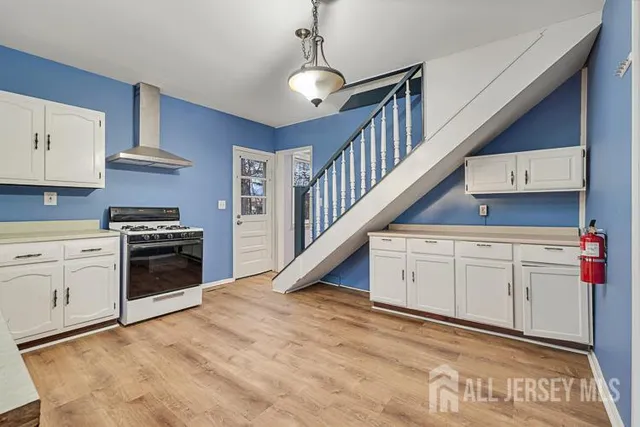 a kitchen with stove cabinets and entryway