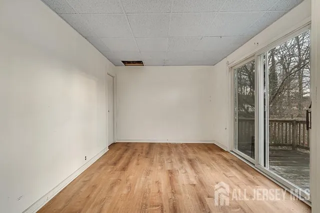a view of a room with wooden floor and city view