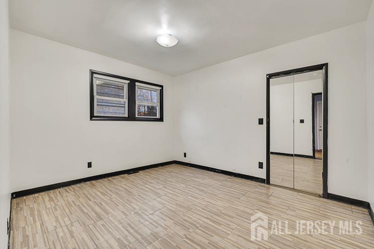 746 Spruce Road North Brunswick, NJ 08902 - Photo 10 of 29 a view of an empty room with wooden floor