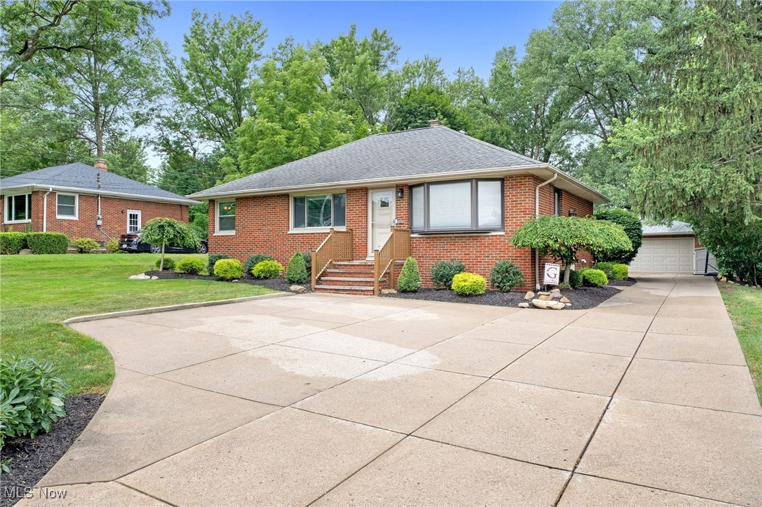 10620 Ridge Road North Royalton, OH 44133 - Photo 2 of 35 View of front of property featuring brick siding, a front lawn, a shingled roof, and an outdoor structure