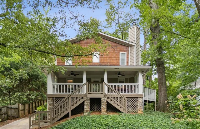 a small house with a tree in front of it