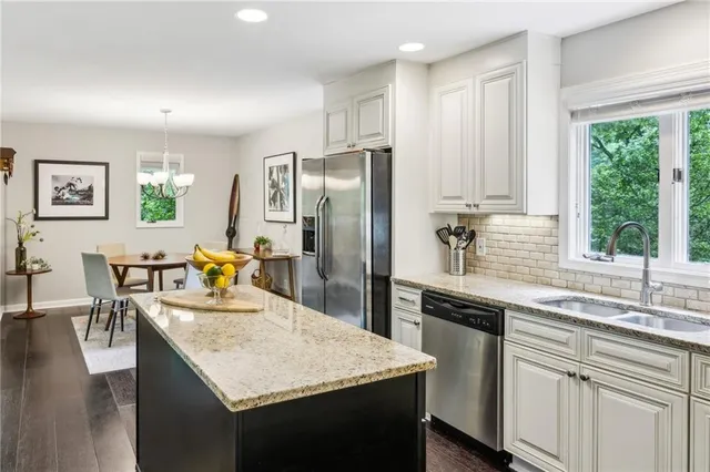 a kitchen with kitchen island a sink stove and refrigerator