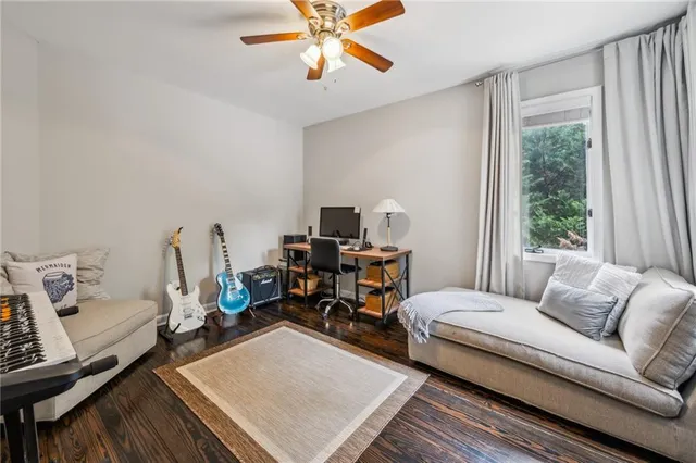 a living room with furniture a rug and a window