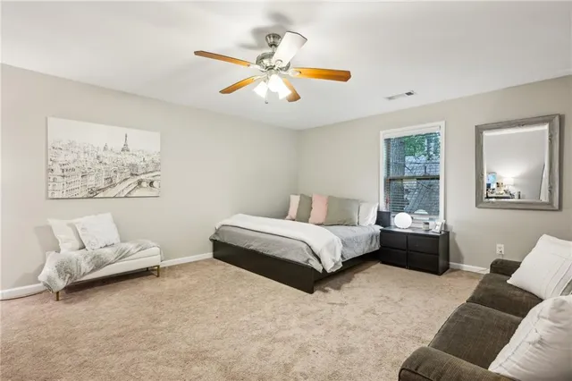 a spacious bedroom with a bed and couch