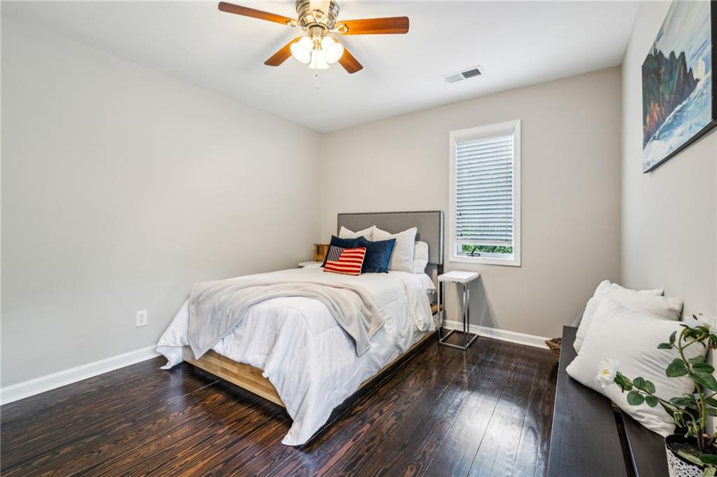 443 Lakeshore Drive Northeast Atlanta, GA 30307 - Photo 22 of 36 a bedroom with a bed and wooden floor