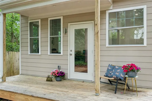 a flower garden and patio with table