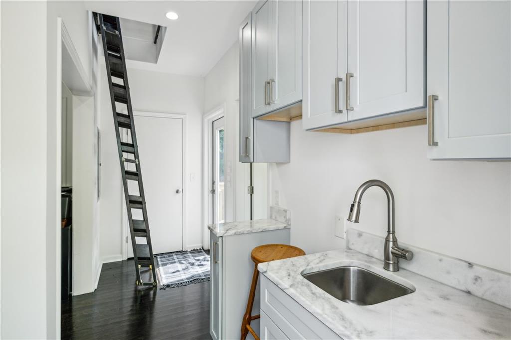 443 Lakeshore Drive Northeast Atlanta, GA 30307 - Photo 28 of 36 a kitchen with stainless steel appliances granite countertop a sink and a wooden floor