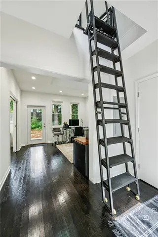 a view of entryway and hall with wooden floor