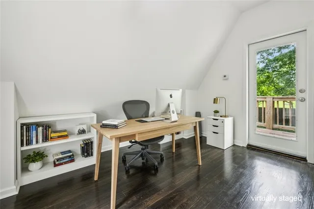 a view of a workspace with furniture window and wooden floor