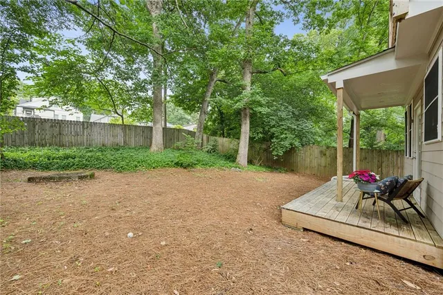 a view of backyard with outdoor seating and green space