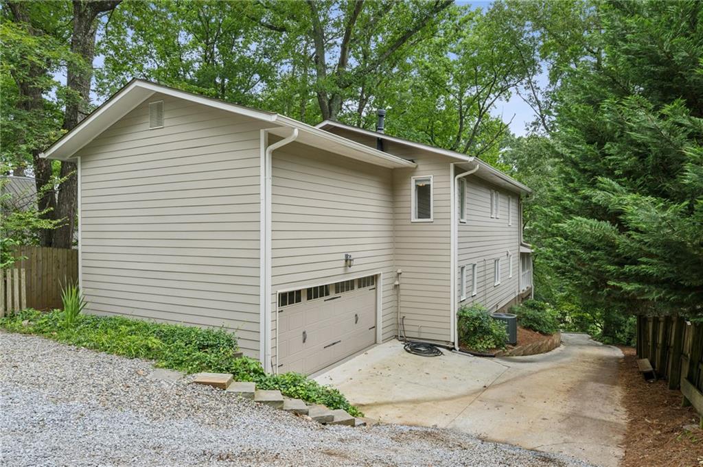 443 Lakeshore Drive Northeast Atlanta, GA 30307 - Photo 36 of 36 a white house with a small yard plants and large tree